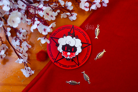 A pin of the lamb from the game 'Cult of the Lamb', with pink flowers. 