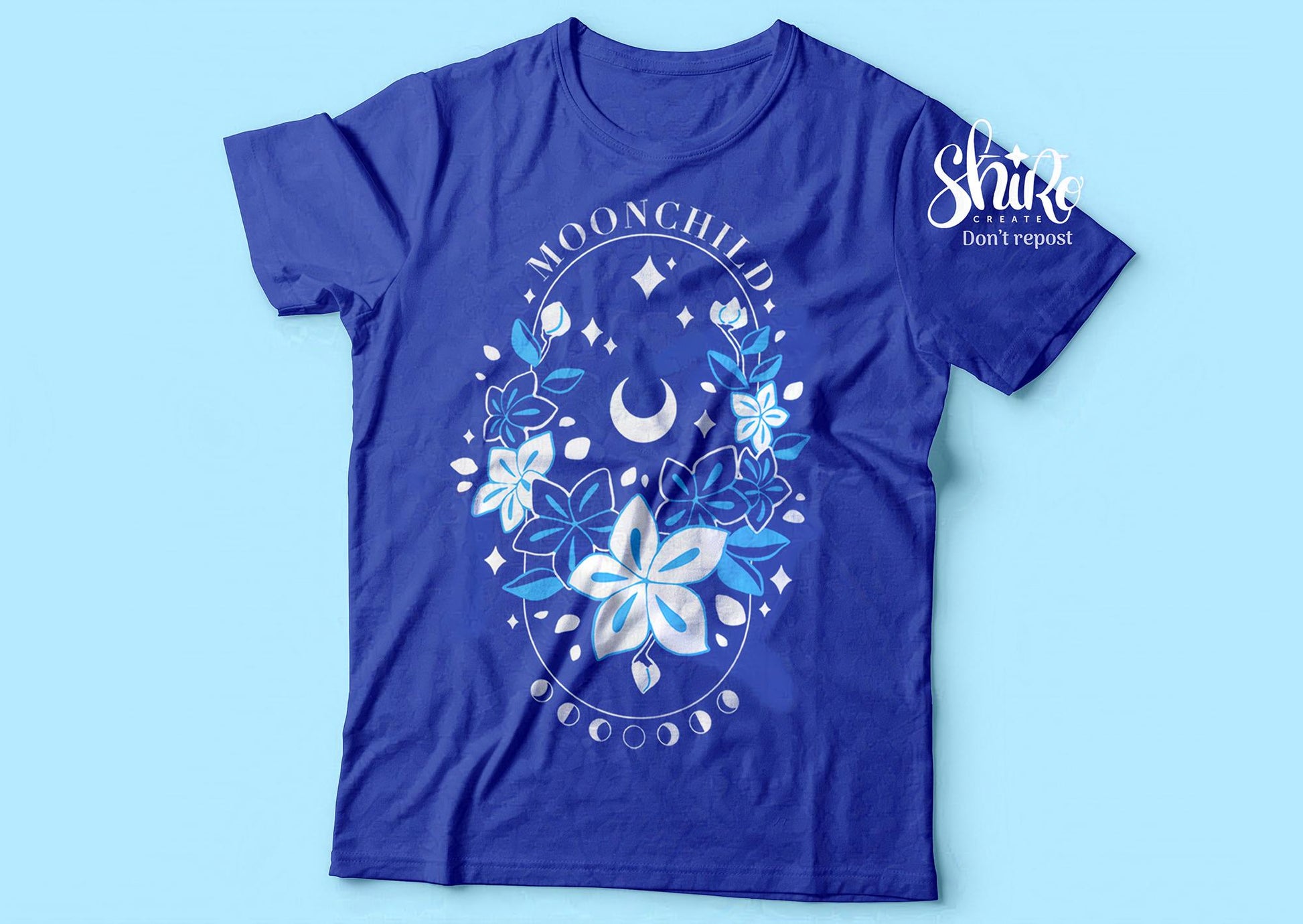 Blue shirt with Moonchild theme. Frasurbane-style central drawing with flowers and cosmic elements, Moonchild&quot text above, lunar phases below.